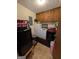 Functional laundry room with appliances, storage cabinets, and neutral flooring at 1710 Crumbley Rd, Mcdonough, GA 30252
