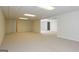Large finished basement with neutral carpet, multiple rooms, and lighting at 1270 Tribble Walk Ct, Lawrenceville, GA 30045