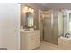 This bathroom includes a stand-up shower, single sink vanity, and a soaking tub at 1270 Tribble Walk Ct, Lawrenceville, GA 30045