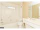 Bright bathroom features a tiled tub and shower combination with white fixtures at 1270 Tribble Walk Ct, Lawrenceville, GA 30045
