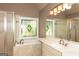 Relaxing bathroom offers a jetted tub under a window, a stand-up shower, and double sinks at 1270 Tribble Walk Ct, Lawrenceville, GA 30045