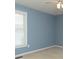Cozy bedroom with light blue walls, a ceiling fan, and natural light from the window at 1270 Tribble Walk Ct, Lawrenceville, GA 30045