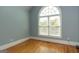 Light-filled bedroom featuring hardwood floors and a large arched window at 1270 Tribble Walk Ct, Lawrenceville, GA 30045