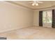 Neutral main bedroom features a ceiling fan, tan carpet, and a window with natural light at 1270 Tribble Walk Ct, Lawrenceville, GA 30045