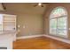 Bright breakfast nook with hardwood floors, large arched window, and a view of the deck at 1270 Tribble Walk Ct, Lawrenceville, GA 30045