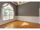 Formal dining room with hardwood floors, wainscoting, and a large window dressed with curtains at 1270 Tribble Walk Ct, Lawrenceville, GA 30045