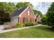 Charming brick home featuring a well-manicured lawn, black shutters, and a convenient two-car garage at 1270 Tribble Walk Ct, Lawrenceville, GA 30045