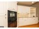Charming kitchen features classic cabinetry, tile backsplash, and modern built-in appliances at 1270 Tribble Walk Ct, Lawrenceville, GA 30045