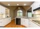 Bright eat-in kitchen boasts granite countertops, white cabinetry, stainless steel appliances, and hardwood floors at 1270 Tribble Walk Ct, Lawrenceville, GA 30045