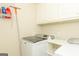 Well-equipped laundry room features a modern washer and ample storage space at 1270 Tribble Walk Ct, Lawrenceville, GA 30045