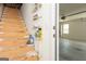 View of the unfinished stairwell leading to the garage with cleaning supplies organized on shelves at 1270 Tribble Walk Ct, Lawrenceville, GA 30045