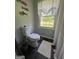 Bathroom showcasing a toilet and window with decorative valance for added privacy at 288 Trickum Creek Rd, Tyrone, GA 30290