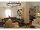 Elegant dining area adjacent to a comfortable living space, illuminated by a chandelier at 288 Trickum Creek Rd, Tyrone, GA 30290