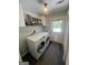 Functional laundry room with modern washer and dryer units and storage at 288 Trickum Creek Rd, Tyrone, GA 30290