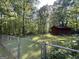 Fenced backyard with a storage shed in a private, wooded setting at 96 Daniel Ct, Mcdonough, GA 30253