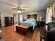 Spacious bedroom with hardwood floors, a ceiling fan, and dark wood furniture at 96 Daniel Ct, Mcdonough, GA 30253