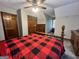 Bedroom featuring a bed with buffalo check bedding, carpeted floor, and classic wood furniture at 96 Daniel Ct, Mcdonough, GA 30253