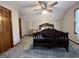 Spacious bedroom with neutral walls, carpeted floor, ceiling fan, and dark wood furniture at 96 Daniel Ct, Mcdonough, GA 30253