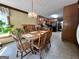 Cozy dining area featuring a wooden table set beneath a chandelier, adjacent to an open kitchen with dark appliances at 96 Daniel Ct, Mcdonough, GA 30253