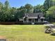 Charming home featuring a welcoming front porch and a spacious front yard with mature trees at 96 Daniel Ct, Mcdonough, GA 30253