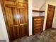 Hallway featuring wood doors, built in shelves, a dresser, and carpeted flooring at 96 Daniel Ct, Mcdonough, GA 30253