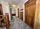 Hallway leading to bedroom with wood doors and trim, carpeted floor, and fresh neutral paint at 96 Daniel Ct, Mcdonough, GA 30253