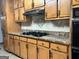 Well-maintained kitchen with wood cabinets, granite countertops, and modern cooking appliances for daily use at 96 Daniel Ct, Mcdonough, GA 30253