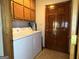 Functional laundry room with a washer and dryer, overhead cabinets, and easy access from the hallway at 96 Daniel Ct, Mcdonough, GA 30253