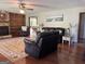 Comfortable living room with fireplace, hardwood floors, built-in shelving, and a ceiling fan at 96 Daniel Ct, Mcdonough, GA 30253