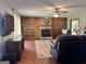 Inviting living room featuring a stone fireplace, hardwood floors, and built-in shelving for a cozy ambiance at 96 Daniel Ct, Mcdonough, GA 30253
