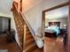 Staircase with chair lift and a view of a bedroom with hardwood floors and dark wood furniture at 96 Daniel Ct, Mcdonough, GA 30253