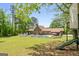 Large backyard with pool, lawn, mature trees, treehouse, and covered patio at 3222 Bay View Dr, Jonesboro, GA 30236