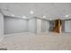Spacious finished basement featuring tile flooring and access to the stairs at 3222 Bay View Dr, Jonesboro, GA 30236