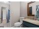 Well-lit bathroom featuring a toilet, vanity, tile flooring, and shower with patterned curtain at 3222 Bay View Dr, Jonesboro, GA 30236