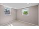A bright bedroom has tile floors, base molding, and two windows at 3222 Bay View Dr, Jonesboro, GA 30236