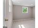 A neutral bedroom has tile floors, base molding, and a window at 3222 Bay View Dr, Jonesboro, GA 30236