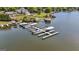 Aerial view of a private boat dock on the water, featuring multiple boat slips and a sunny waterfront setting at 3222 Bay View Dr, Jonesboro, GA 30236