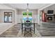 Modern dining area with outdoor views and stylish decor, near a cozy fireplace at 3222 Bay View Dr, Jonesboro, GA 30236
