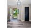 Inviting foyer with stylish flooring, dark door, light walls, and contemporary light fixture at 3222 Bay View Dr, Jonesboro, GA 30236
