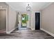 Inviting foyer with stylish flooring, dark door, light walls, and contemporary light fixture at 3222 Bay View Dr, Jonesboro, GA 30236