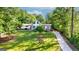 Spacious property showcasing a charming home with mature trees and a long driveway at 3222 Bay View Dr, Jonesboro, GA 30236