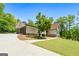 Exterior side view featuring attached garage and stone facade at 3222 Bay View Dr, Jonesboro, GA 30236