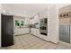 Bright kitchen featuring white cabinetry, stainless appliances, tile flooring, and backyard views at 3222 Bay View Dr, Jonesboro, GA 30236