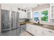 Bright kitchen with stainless steel appliances, granite countertops, and a view of the backyard at 3222 Bay View Dr, Jonesboro, GA 30236