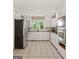 Bright, functional kitchen with white cabinetry, stainless steel appliances, and tile flooring at 3222 Bay View Dr, Jonesboro, GA 30236