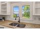 Close up on kitchen sink with a view of the outdoors through a double window at 3222 Bay View Dr, Jonesboro, GA 30236