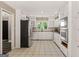 Bright, functional kitchen with white cabinetry, stainless steel appliances, and tile flooring at 3222 Bay View Dr, Jonesboro, GA 30236