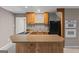 A kitchenette boasts wooden cabinets, granite countertops, and black appliances at 3222 Bay View Dr, Jonesboro, GA 30236