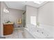 Well-lit bathroom with a shower, soaking tub, granite countertops, and ceramic tile flooring at 3222 Bay View Dr, Jonesboro, GA 30236