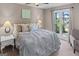 Comfortable main bedroom showcasing serene lake views, soft carpet, and ceiling fan at 3222 Bay View Dr, Jonesboro, GA 30236